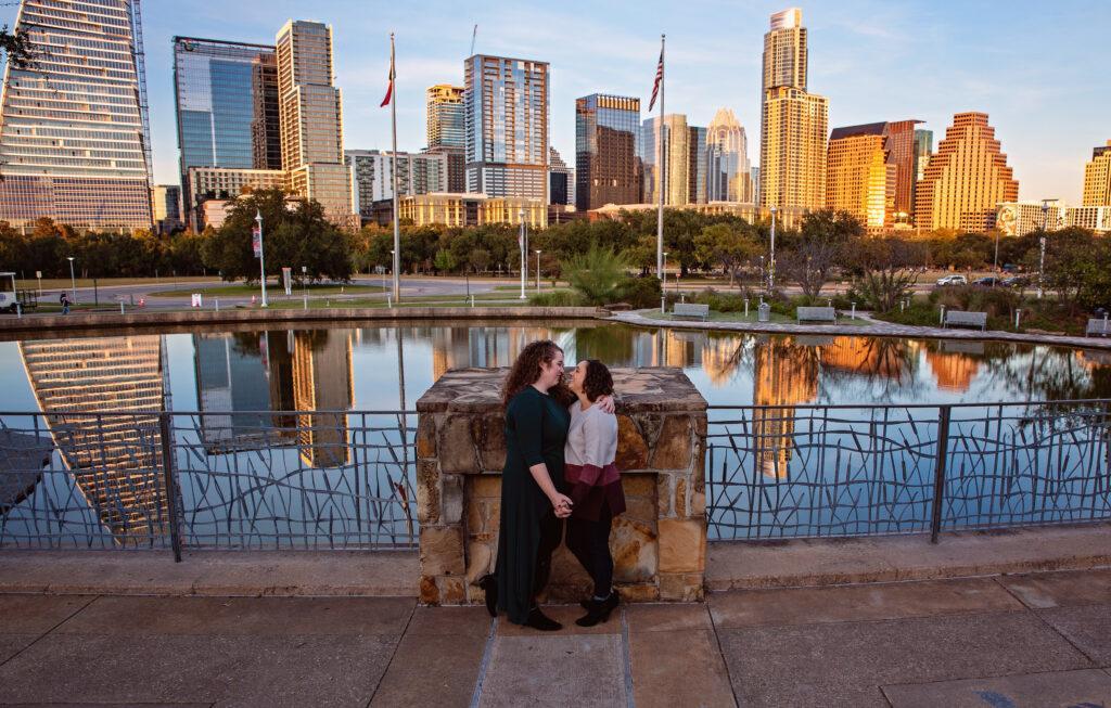 A view of the downtown Austin skyline with an LGBT couple