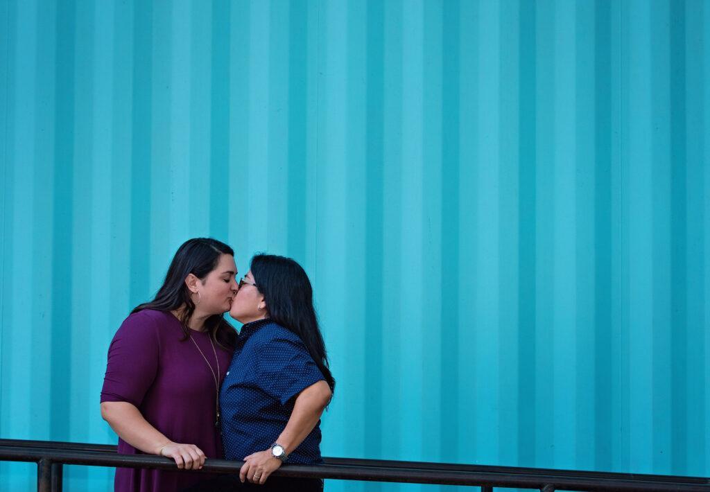 An LGBT couple with a blue background